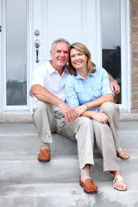 Senior couple at new home. Retirement security concept.